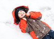 boy lies in snow