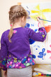 Photo: Small Caucasian child painting with brush and paint Small Caucasian child painting with brush and paint
