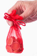 Photo: Hand hold red bag with euro coins Hand hold red bag with euro coins