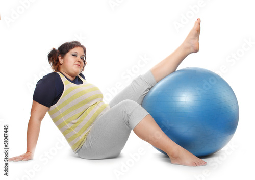 Photo: Overweight woman exercising on a white background. Overweight woman exercising on a white background.