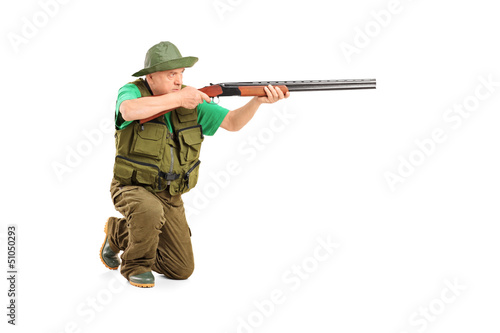 Photo: A male hunter shooting with a rifle A male hunter shooting with a rifle