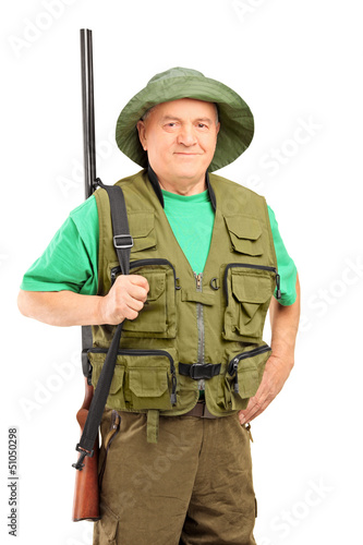 Photo: A mature hunter holding a rifle and looking at camera A mature hunter holding a rifle and looking at camera