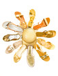 Sun shaped golden sandals still life fashion composition
