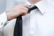 Businessman adjusting tie