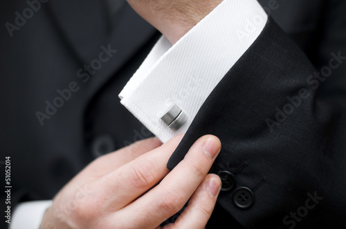 Photo: Cuff link, man is getting dressed Cuff link, man is getting dressed