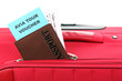 Passport and ticket on suitecase close-up