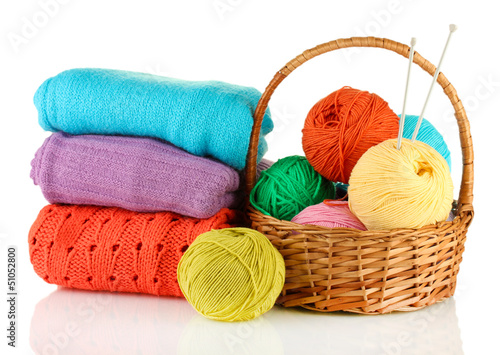 Photo: Sweaters and balls of wool isolated on white Sweaters and balls of wool isolated on white