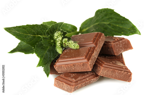 Photo: Pieces of chocolate and mint isolated on white Pieces of chocolate and mint isolated on white