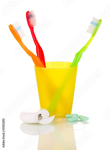 Photo: Toothbrushes, chewing gum and dental floss isolated on white Toothbrushes, chewing gum and dental floss isolated on white