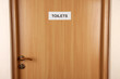 Toilet sign on wooden door