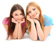 Two girl friends smiling isolated on white