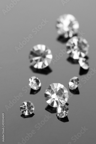 Photo: Beautiful shining crystals (diamonds), on grey background Beautiful shining crystals (diamonds), on grey background