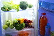 Open refrigerator with vegetarian food