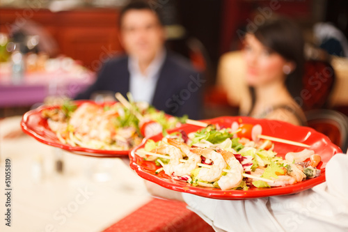 Photo: Waiter serving sea food Waiter serving sea food