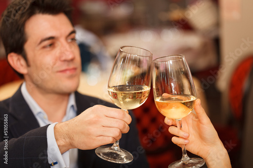 Photo: Couple toasting wineglasses Couple toasting wineglasses