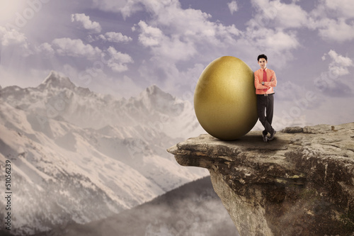 Photo: Business leader and golden egg on top Business leader and golden egg on top