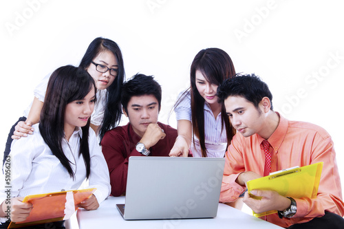 Photo: Business team discussion with laptop on white Business team discussion with laptop on white