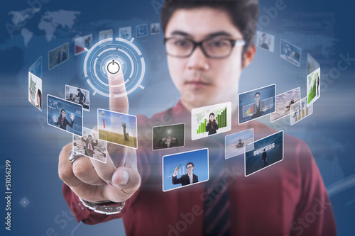 Photo: Businessman click on touchscreen with photos Businessman click on touchscreen with photos