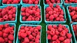 Baskets of raspberries at a farmers market