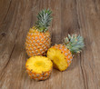two Pineapples with basket on wooden grunge background
