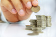Hand put coin to stack