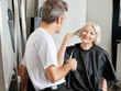 Client Instructing Hairdresser In Salon