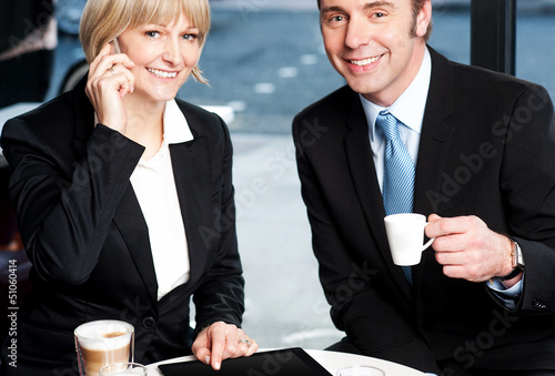 Photo: Two business professionals at coffee shop Two business professionals at coffee shop