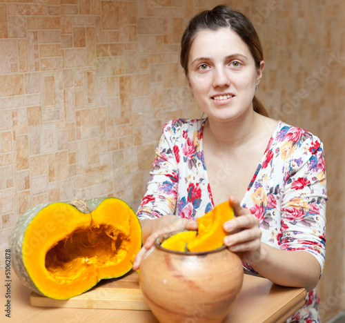 Photo: woman cooking pumpkin in pot woman cooking pumpkin in pot