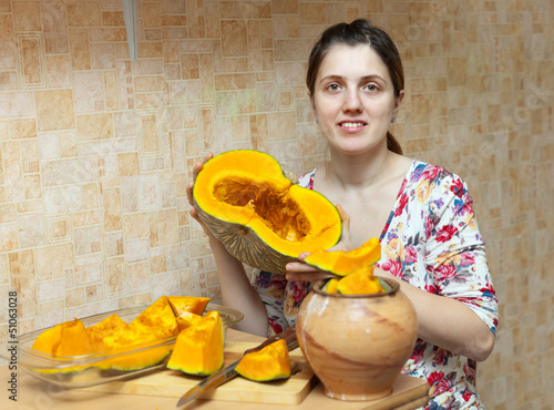Photo: Woman cooks pumpkin Woman cooks pumpkin