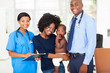 Photo: pediatric medical professionals with mother holding her baby pediatric medical professionals with mother holding her baby