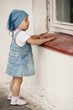 young girl looks to the window