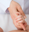 baby's hand with mother's finger