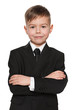 Smiling young boy in black suit