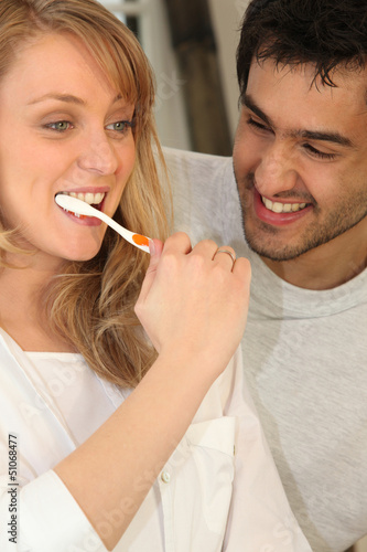 Photo: Couple brushing teeth Couple brushing teeth