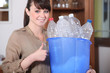 Woman recycling plastic bottles
