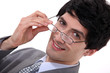 Businessman peering over his glasses