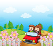 A red car with a young girl and boy