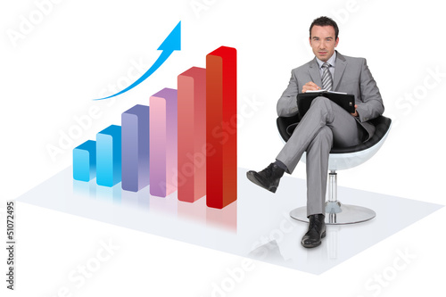 Photo: Businessman with an upwards growth chart Businessman with an upwards growth chart