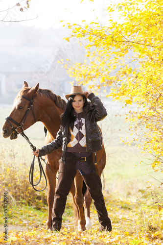 Photo: equestrian with her horse in autumnal nature equestrian with her horse in autumnal nature