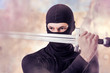 Ninja with sword outdoor  in smoke