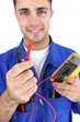 Electrician displaying voltmeter