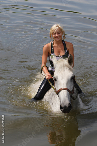Photo: Girl swiming with her horse Girl swiming with her horse