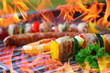 barbecue with flames and vegetable spit