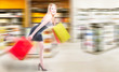 Blonde woman running in a shopping spree