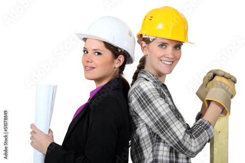 Photo: craftswoman and businesswoman standing back to back craftswoman and businesswoman standing back to back