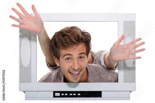 Photo: Couple behind television Couple behind television