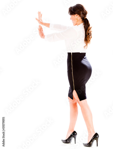 Photo: Business woman pushing an object Business woman pushing an object