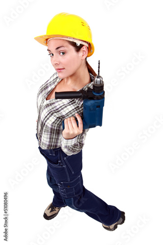 Photo: A female manual worker with a drill. A female manual worker with a drill.