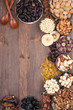 Frame of variety of fruits and nuts on a dark wooden surface