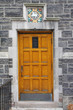 wooden door of stone college building